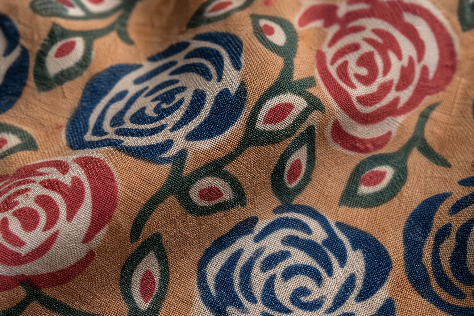 Macro detail of floral block printed fabric showing tonal depth, absorbed dye, and woven texture