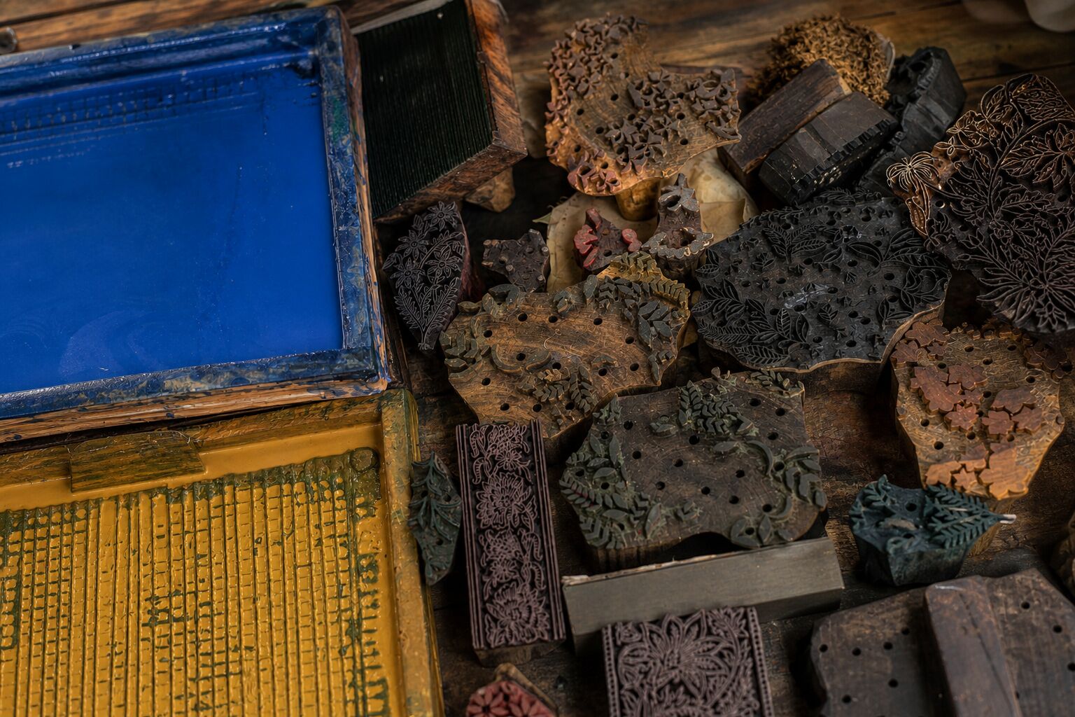 Hand carved wooden blocks and natural dye trays used for authentic Indian block printing