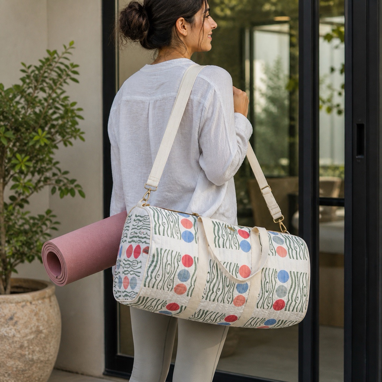 Hand block printed duffle bag in a bold graphic print carried with a yoga mat